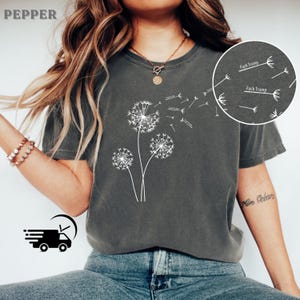 May include: Dark gray t-shirt featuring a white dandelion design with the text "Fuck Trump" on the dandelion seeds. The word "Pepper" is printed at the top left.