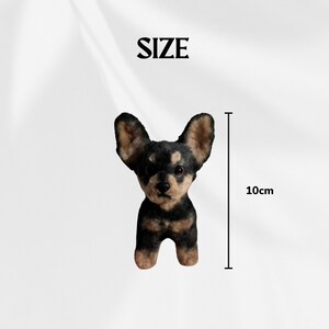 May include: A small, handcrafted dog figurine, primarily black and tan, with large, upright ears. The figurine is approximately 4 inches tall, as indicated by the measurement graphic. The word "SIZE" is above the dog.