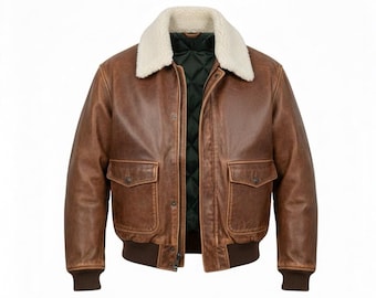 May include: A brown leather bomber jacket with a cream-colored shearling collar. The jacket features two front pockets, a dark green quilted lining, and ribbed cuffs and hem. The jacket has a zipper closure.