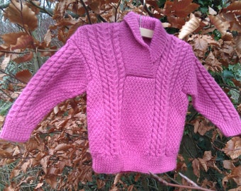 Girl's childs toddlers pink aran cable hand knitted sweater with shawl neck collar