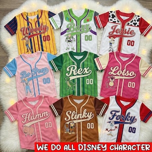 May include: A collection of baseball-style jerseys featuring characters from the movie Toy Story. Each jersey is a different color and has a character's name, number "00", and a character graphic. The jerseys include Woody, Buzz, Jessie, Bo Peep, Rex, Lotso, Hamm, Slinky, and Forky.