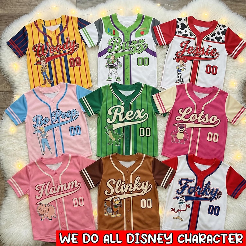 May include: A collection of baseball-style jerseys featuring characters from the movie Toy Story. Each jersey is a different color and has a character's name, number "00", and a character graphic. The jerseys include Woody, Buzz, Jessie, Bo Peep, Rex, Lotso, Hamm, Slinky, and Forky.