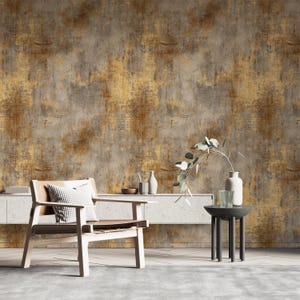 May include: A modern living room scene featuring a wooden armchair with a leather seat and a checkered pillow. A small black side table holds a vase and a glass. The background is a textured wall with gold and gray tones.