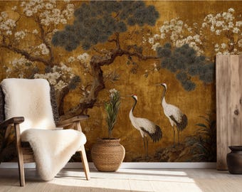 Puede incluir: Un sillón de madera con una manta de piel de oveja color crema se encuentra frente a un mural dorado que representa un árbol, flores y dos grullas. Una maceta tejida contiene una planta, y también hay un jarrón oscuro y un panel de madera.