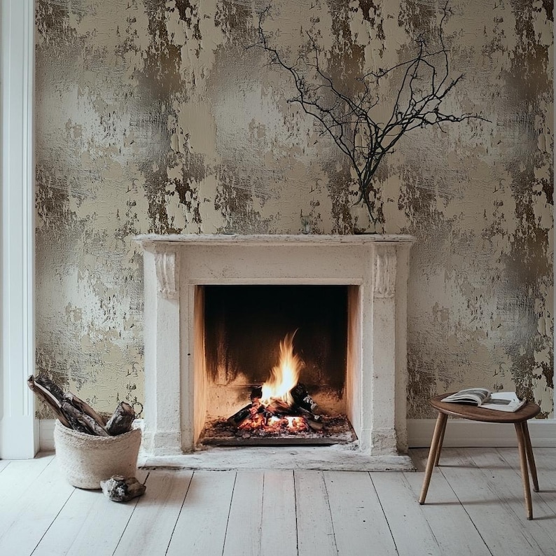 May include: A cozy living room scene featuring a fireplace with a burning fire. The fireplace is framed by a white mantel and set against a textured, neutral-toned wallpaper. A small wooden side table with a book and a woven basket with logs complete the warm ambiance.