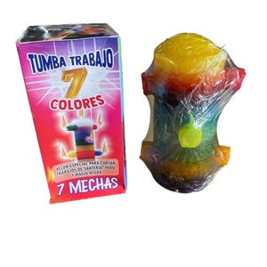 May include: A colorful candle with seven wicks and a box with the text "TUMBA TRABAJO 7 COLORES". The candle is wrapped in clear plastic and has a rainbow of colors, including yellow, red, and green. The box also has text in Spanish.