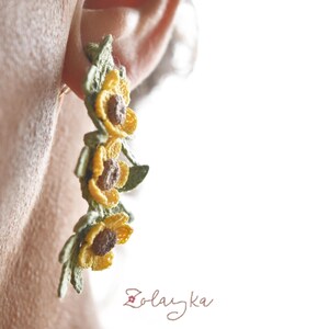 Handmade micro crochet buttercup earrings with yellow flowers and green leaves on 18K gold studs, 5 cm long.