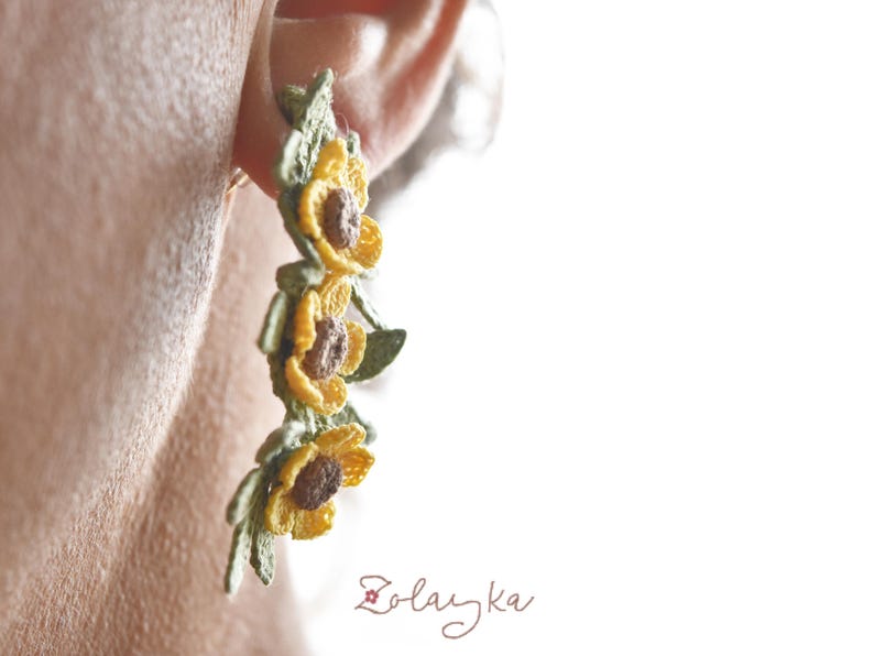 Handmade micro crochet buttercup earrings with yellow flowers and green leaves on 18K gold studs, 5 cm long.