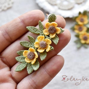 Handmade micro crochet buttercup earrings with yellow flowers and green leaves on 18K gold studs, 5 cm long.