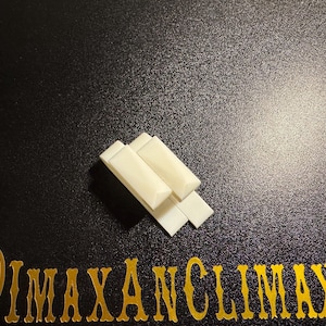 May include: Four off-white rectangular objects are stacked on a black surface. The objects are arranged in a slightly overlapping pattern. The text "@IMAXANCLIMAX" is displayed in gold lettering at the bottom of the image.