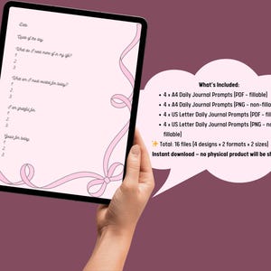May include: A digital download of daily journal prompts displayed on a tablet. The prompts are on a pink background with a decorative ribbon design. The image includes a list of what's included, such as PDF and PNG files.