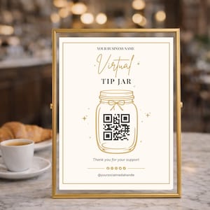 May include: A framed sign with the words "Virtual Tip Jar" in gold script. The sign features a mason jar graphic with a QR code and the text "Thank you for your support." The frame is gold.