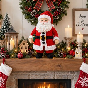 May include: A crocheted Santa Claus doll with a red coat, white trim, black belt, and a full white beard. The doll stands on a wooden mantelpiece decorated with a wreath, candles, small wooden houses, pinecones, and red Christmas stockings.