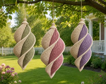 May include: Three spiral-shaped hanging ornaments featuring a crochet texture. Each ornament consists of two alternating colours: one in cream paired with either olive green, dusty rose, or lavender. Each piece has a light-coloured wooden cap.