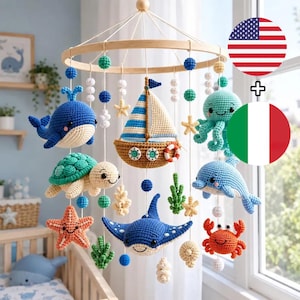 May include: A nautical-themed baby mobile featuring crocheted sea creatures including a blue whale, green turtle, orange starfish, stingray, octopus, dolphin, and crab, along with a sailboat, all suspended from a circular wooden frame.