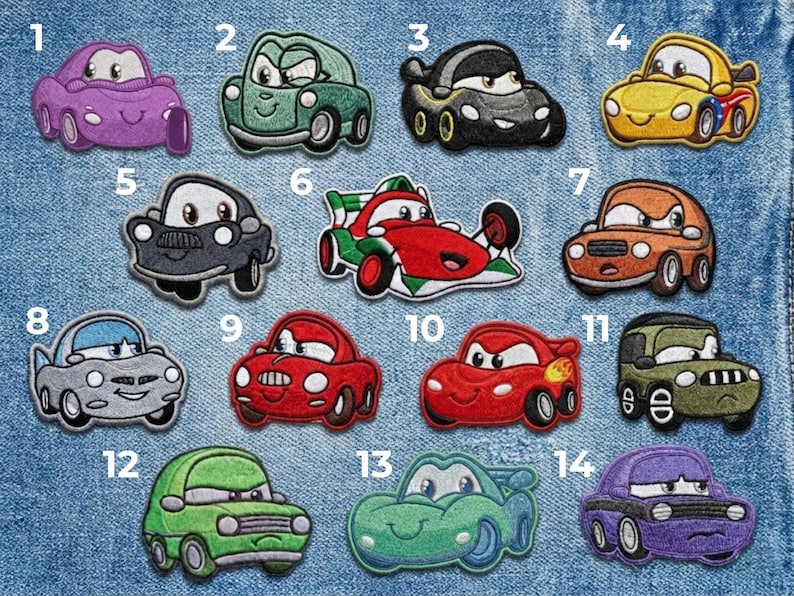 A set of 14 vibrant racing car embroidered iron-on patches featuring expressive faces in colors like red, yellow, green, and purple, displayed on a blue denim background.