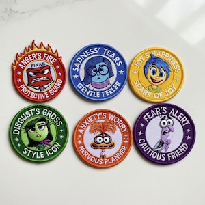 May include: A set of six embroidered patches, each depicting a character from the Pixar film "Inside Out." The patches feature Anger, Sadness, Joy, Disgust, Anxiety, and Fear. Each circular patch has a unique design and accompanying text.