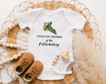 Smallest Member of the Fellowship Baby Bodysuit | Hobbit-Inspired Infant Baby Outfit, Unisex T-Shirt & White Bib