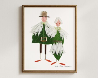 May include: Framed artwork featuring two whimsical figures crafted from natural elements. The figures have green leaf bodies, white flower collars, and twig legs. One figure wears a hat. The artwork is in a gold frame and signed by the artist.