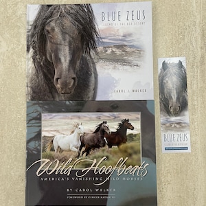 May include: Two book covers featuring wild horses. The top cover is blue and white with the title "Blue Zeus: Legend of the Red Desert" and the author's name "Carol J. Walker". The bottom cover is black with the title "Wild Hoofbeats: America's Vanishing Wild Horses" and the author's name "By Carol Walker".