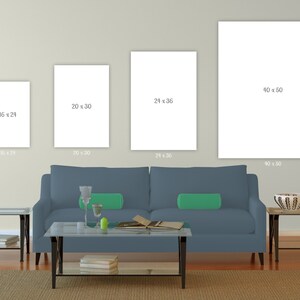 May include: Three white framed canvas prints of different sizes hanging on a light beige wall above a blue sofa. The canvas prints are blank and have the dimensions 16 x 24 inches, 20 x 30 inches, and 40 x 50 inches printed below each canvas.