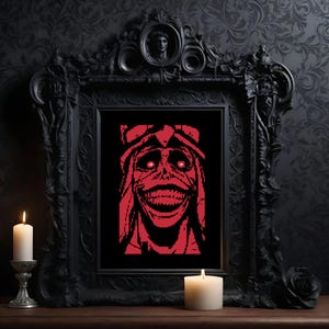 May include: A rectangular framed wall art piece featuring a pixelated red and black illustration of a grinning, wide-eyed creature with sharp teeth. The artwork is encased in an ornate, heavy black frame with intricate carvings and a central crest.