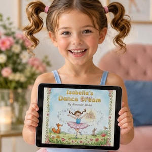 Puede incluir: Una niña sonriente sostiene una tableta que muestra la portada de "Isabella's Dance Dream" de Alexander Welch. La portada presenta una bailarina, un zorro y un conejo. Lleva un tutú rosa y un maillot azul.