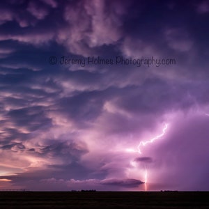 Kansas supercell thunderstorm with lightning bolt and mammatus clouds