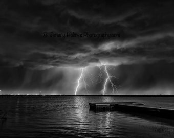 lightning bolt over lake in Texas from a supercell thunderstorm in black and white