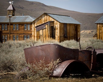 fine art print perfect wall decor of an old rusty car close to the old school in the ghost town of Bodie California