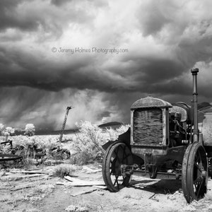 Mccormick-Deering farm tractor with thunderstorm in Colorado in black and white