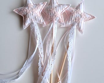 May include: Three pink and white star-shaped wands with white lace ribbon and pink ribbon streamers.