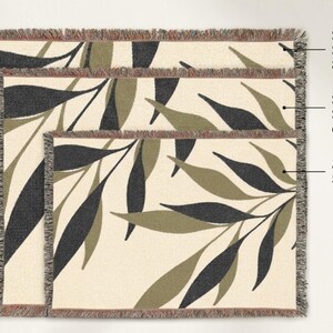 Olive green woven cotton throw blanket size guide showing three options: 52x37 accent size, 60x50 signature size, and 80x60 statement size with botanical branch design.