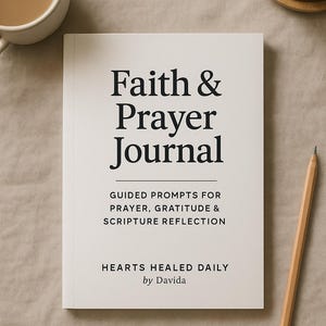 May include: A white journal titled "Faith & Prayer Journal" with black text. The journal includes prompts for prayer, gratitude, and scripture reflection. A pencil and a cup of coffee are next to the journal.