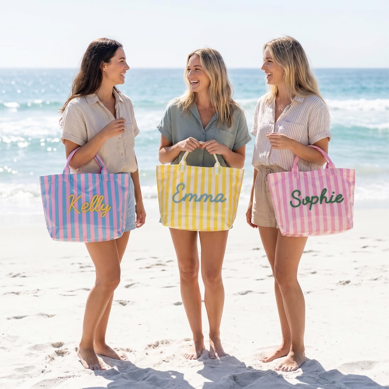May include: Three rectangular tote bags with vertical stripes. The first bag is blue and pink with the name Kelly in yellow. The second bag is yellow and white with the name Emma in green. The third bag is pink and white with the name Sophie in green.