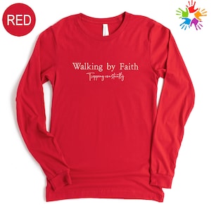 A red long-sleeved t-shirt with the text "Walking by Faith" printed on it.