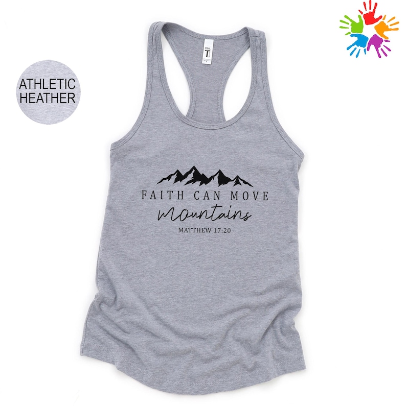 A gray athletic tank top with a graphic design featuring mountains and the text "Faith can move mountains" along with a Bible verse reference.