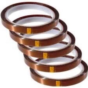 May include: Five rolls of brown thermal tape with a white core and a small gold-colored square on each roll. The rolls are stacked diagonally, showcasing the product's design and color.
