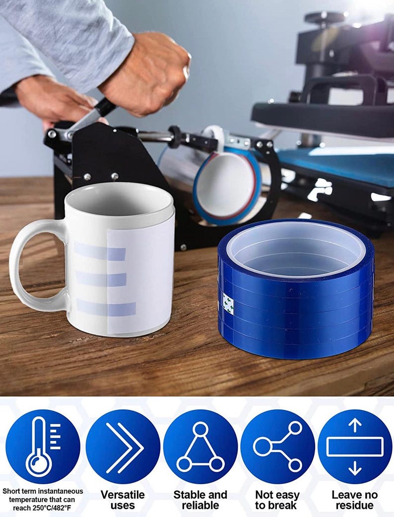 May include: A white ceramic mug with a light blue design, next to a roll of blue tape. The mug is on a wooden surface, with a heat press machine in the background. The tape is for sublimation, with features like short term instantaneous temperature, versatile uses, stable and reliable, not easy to break, and leave no residue.