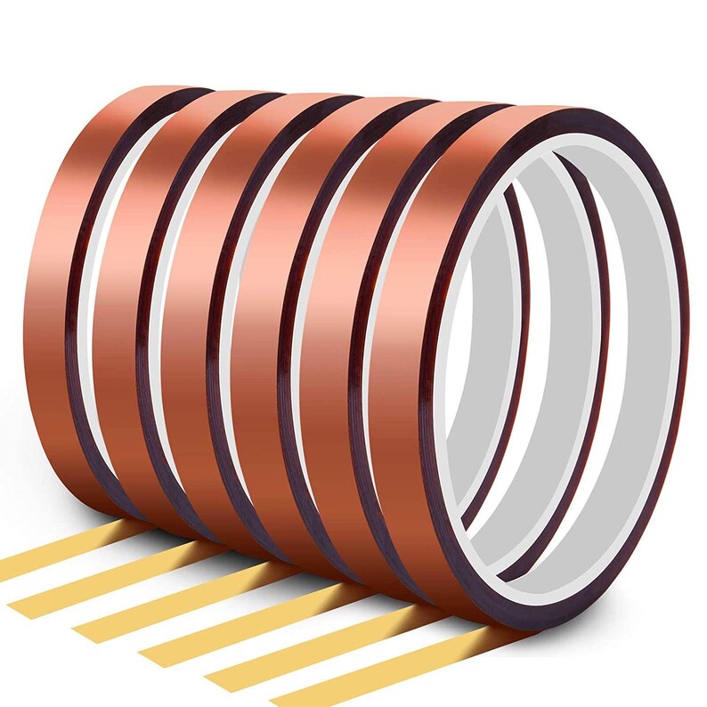 May include: A roll of copper-colored heat transfer tape with a white interior. Several strips of yellow tape are visible at the bottom. The tape is likely used for crafting or DIY projects.