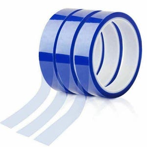 May include: Several rolls of clear double-sided tape with blue edges are stacked on top of each other. The tape is transparent, and several strips are pulled away from the rolls.