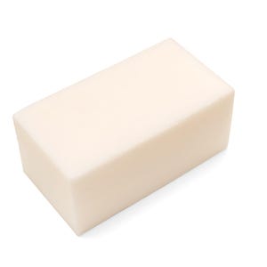 May include: A rectangular bar of soap with a light beige color. The soap has a smooth, solid appearance and is likely unscented. The shape is a simple, block-like design, suitable for general use.