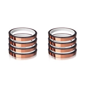 May include: Two stacks of heat transfer tape rolls. Each roll is copper-colored with a white inner ring. The rolls are stacked neatly, showcasing the product's design and potential for crafting or DIY projects. The background is plain white.