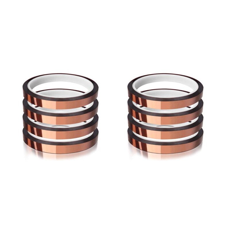 May include: Two stacks of heat transfer tape rolls. Each roll is copper-colored with a white inner ring. The rolls are stacked neatly, showcasing the product's design and potential for crafting or DIY projects. The background is plain white.