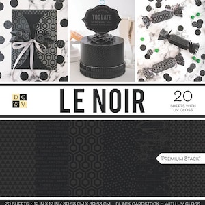 May include: A collection of black papercrafting supplies. The image includes a black cake with a sign that reads "It is never too late to be what you might have been." Also shown are black and white patterned paper, confetti, and candy-shaped decorations. The text "LE NOIR" is displayed.