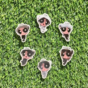 May include: A collection of cartoon-style stickers featuring characters with large eyes and various hairstyles. Each sticker has a name printed on it, including "Keeno", "Soul", "Allng", "Inhak", "Theo", and "Jongseob". The stickers are set against a green background.