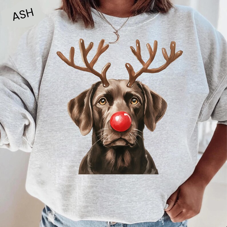 A gray sweatshirt with a graphic of a dog wearing a red nose and antlers, resembling a reindeer.
