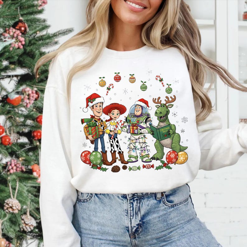 A woman wearing a white sweater with a Christmas-themed graphic design featuring characters from the Toy Story franchise.