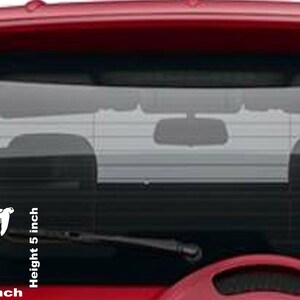 May include: White vinyl decal of four sea turtles swimming upwards. The decal is 6.5 inches wide and 5 inches high, designed for application on a car window. The turtles are stylized with detailed shells.
