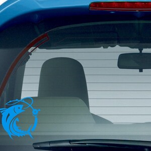 May include: A blue vinyl decal of a fish hooked by a fishing line, applied to the rear window of a blue car. The fish is stylized with curved lines, suggesting movement. The decal is a popular accessory for fishing enthusiasts.